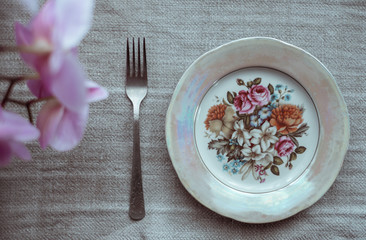 table setting for breakfast. plate and fork on the tablecloths 
