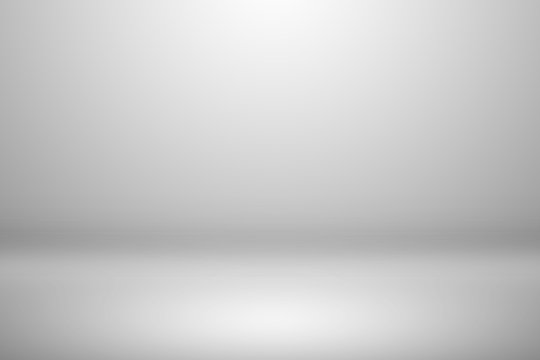 Abstract empty white and gray gradient soft light background of studio room for art work design.
