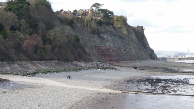 High Angle View Of Family At Beach By Rock Formations