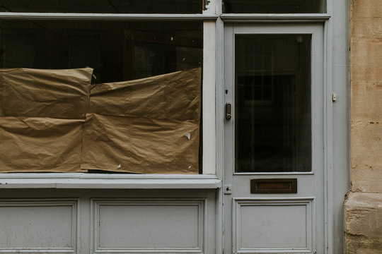 Brown paper behind the closed shop glass window during coronavirus pandemic