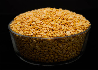 Toor dal or split yellow lentils in a glass bowl isolated
