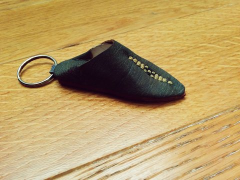 High Angle View Of Babouche Key Ring On Wooden Table