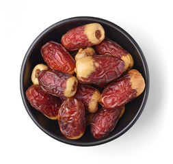 Bowl of dates isolated on white, from above