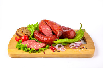 
sausage on a cutting board with herbs and vegetables white background