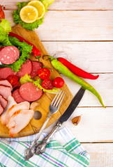 sausage meat with vegetables and herbs wooden background