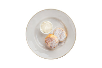 fried cottage cheese pancakes with sour cream isolated on white background