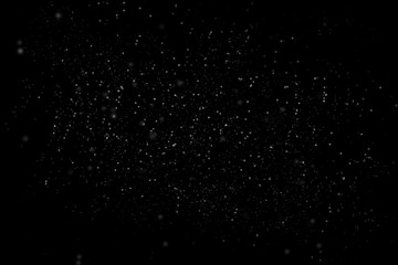 Dust particle on black abstract background. White dust element bokeh pattern flying in a dark