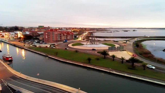 Aerial evening traffic on a traffic circle and bridge spanning a canal Aveiro, Portugal, equivalent to Venice