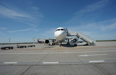 Fototapeta na wymiar Aircraft parked on a runway, passenger teletrap connected