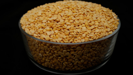 Toor dal or split yellow lentils in a glass bowl isolated
