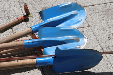 Blue shovels on concrete plate