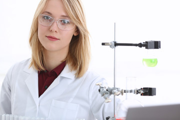 Smiling beautiful technician woman portrait and sample bottle with poison fluid. Medical worker in...