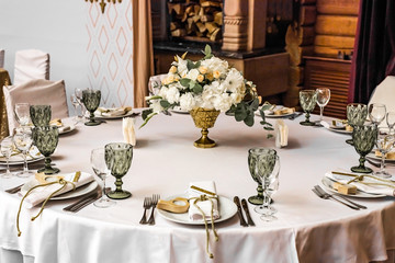 White wedding decoration in restaurant. Luxury wedding arrangement. Wedding banquet decoration. Tables in restaurant decorated with beautiful white peonies and roses