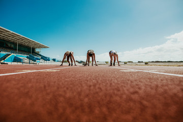 Athletes at starting line on running track