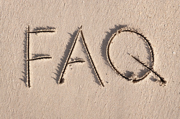 Simple FAQ message, the abbreviation for Frequently Asked Questions, handwritten outdoors on clean smooth sand beach