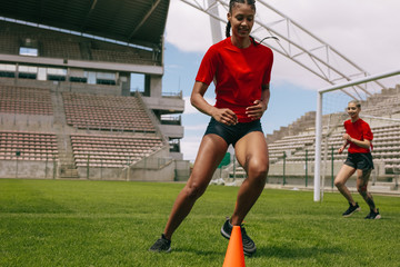 Woman training on football field