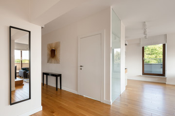 White corridor with wooden floor