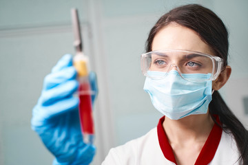 Close up of serious brunette woman that working in lab