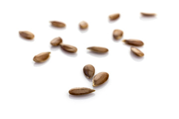 Obraz premium Seeds Linum isolated on white. Pile healthy Linseed food on organic background. Superfood high vitamin e, antioxidant, omega-3, protein and dietary fiber for healthy food.