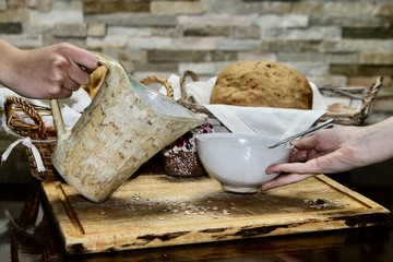 hands holding handmade bowl and jug