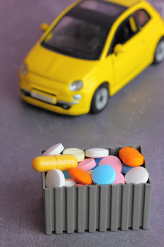 Medical preparations  self-delivery. A yellow toy car picks up  pills and tablets
