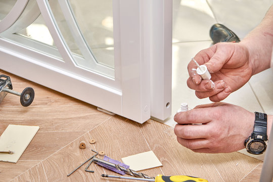 Sliding glass doors repair. Worker install end cap. White sliding glass doors with overlays decor