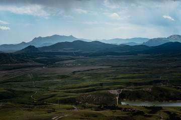 Fototapeta premium Incredibly beautiful landscape view from the mountain to the valley before a thunderstorm in spring.