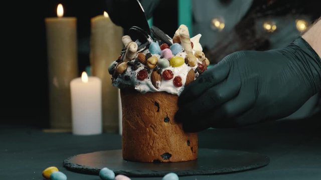 Tasting a traditional Easter cake, a woman cuts a cake with a knife, a slow-motion shot