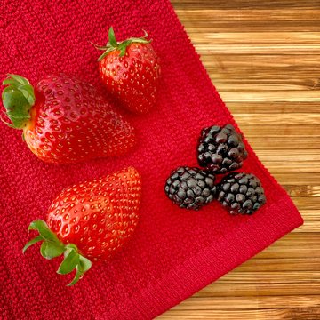 Strawberries And Blackberries On A Wooden Kitchen Counter. Ingredients For Baking A Summer Berry, Strawberry And Blackberry, Pie Or Tart. Top Down Flat Lay View. Red And Summery Food Flat Lay