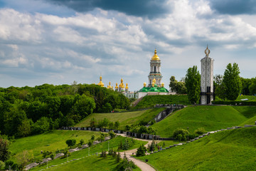 Fototapeta na wymiar Nice spring panoramic view of Pechersk Lavra in Kiev Ukraine with green hills at spring sunny day
