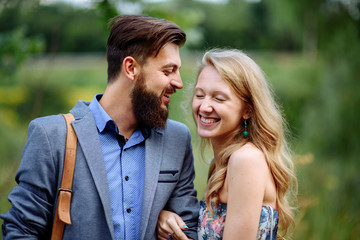 Fototapeta premium Close up portrait of happy couple. Curley smart girl and bearded handsome man