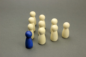 Wooden figures of people. A successful leader leads a team, a business concept