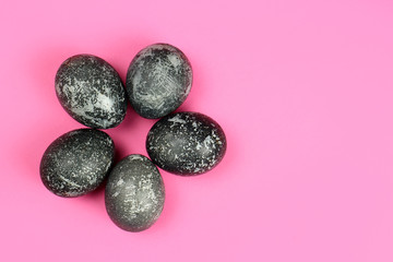 violet Easter eggs on a pink background. Copy space