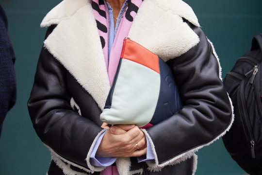 Woman with blue, orange and white Chanel leather bag and sheepskin jacket on January 14, 2019 in Milan, Italy
