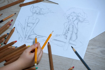In the picture, the image of a girl, a sketch made by graphite pencil