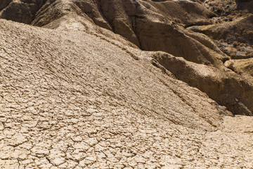 yellow sand hills in nature reserve in south coast of Issyk Kul with deep blue sky in Kyrgyzstan
