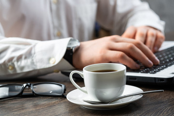 Businessman sitting at desk and using laptop