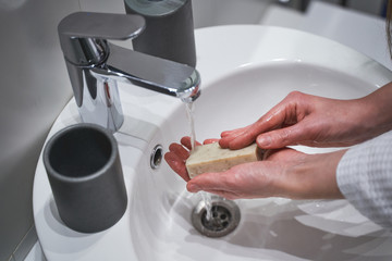 Girl using a soap bar for hand hygiene