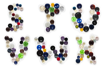 Miscellaneous colored buttons from clothes in the form of letters