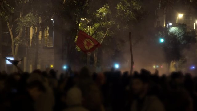 Fire, Chaos and Riots in a city. Radical protests waving revolution flags