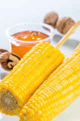 Boiled corn kernels in foam cup side view isolated on white background.