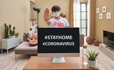Coronavirus and stay home concept, man in in the home and brown living room background.