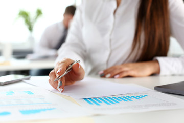 Female arm in suit hold silver pen and pad making note in office closeup. Deal consult delivery signature financial inspector job fill survey form discuss strategy project negotiation concept