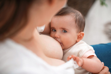 Process of breastfeeding. Mother is breastfeeding a child.