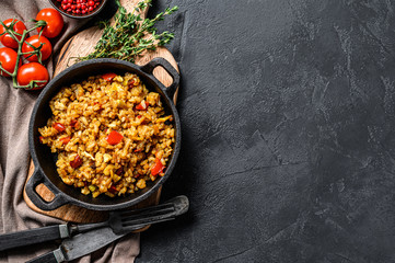 Fried Rice with Vegetables and eggs. Chinese Cuisine.  Black background. Top view. Copy space