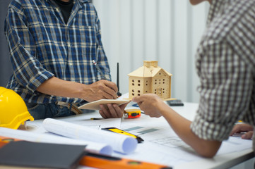 Two male architects in the office discussed housing construction projects.