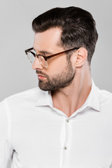 Obraz premium bearded and handsome businessman in glasses isolated on grey