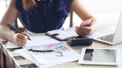 close up of a young woman writing on a notebook