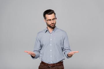 handsome businessman in glasses and shirt gesturing isolated on grey