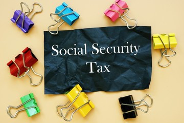 The photo says Social Security Tax. Notepad, pen, marker.